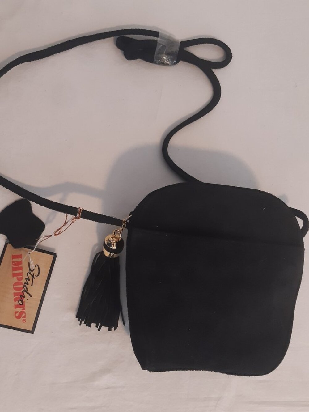 STUDIO IMPORTS, BLACK LEATHER SUEDE LOOK CROSS BODY BAG W/ TASSLE 7" X 7" X 2.5"